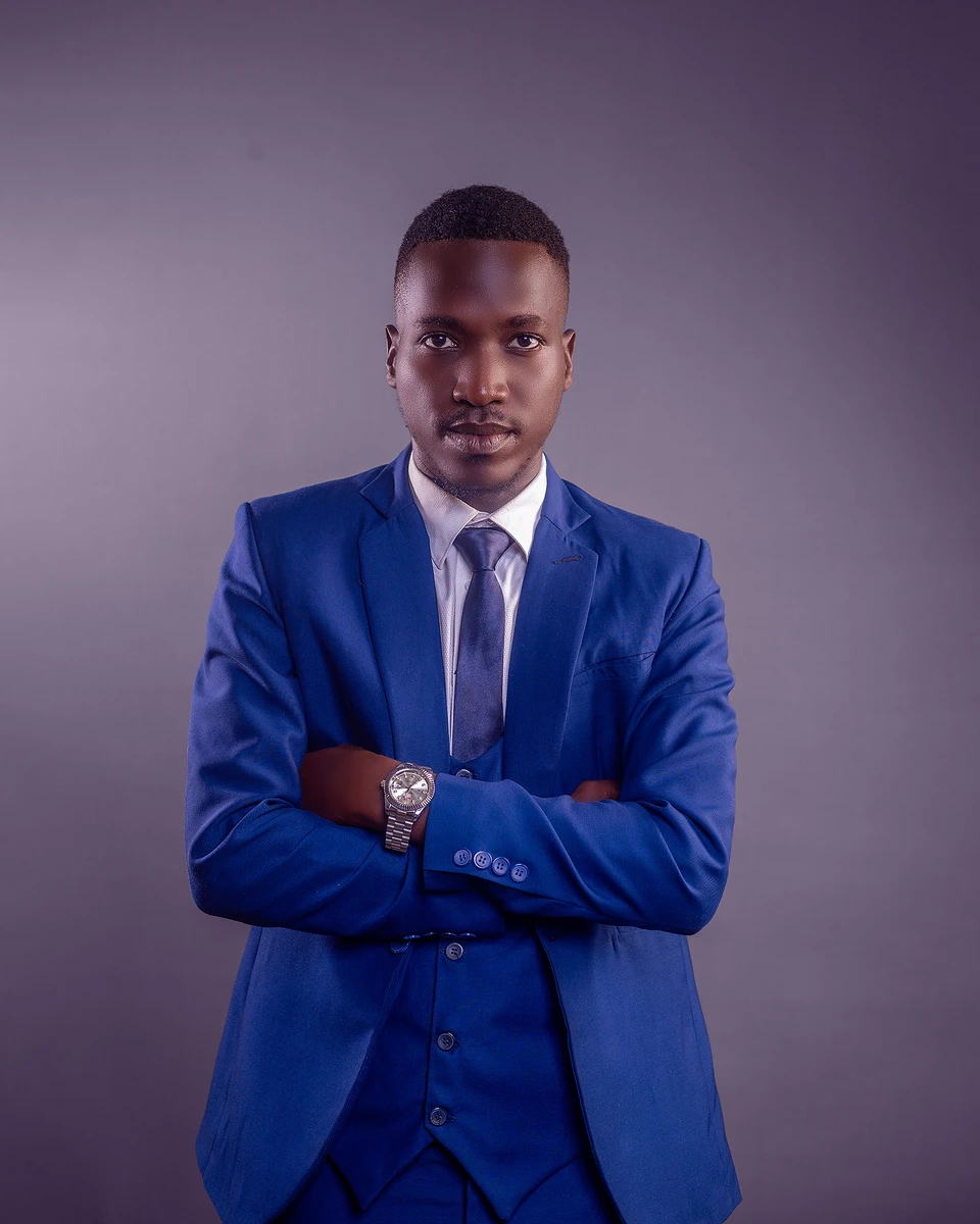 Kelvin David Masiga, CEO of MAS-G Photography, in a blue suit